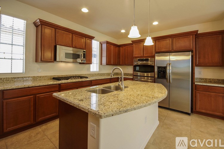 A kitchen with granite countertops and stainless steel appliances.