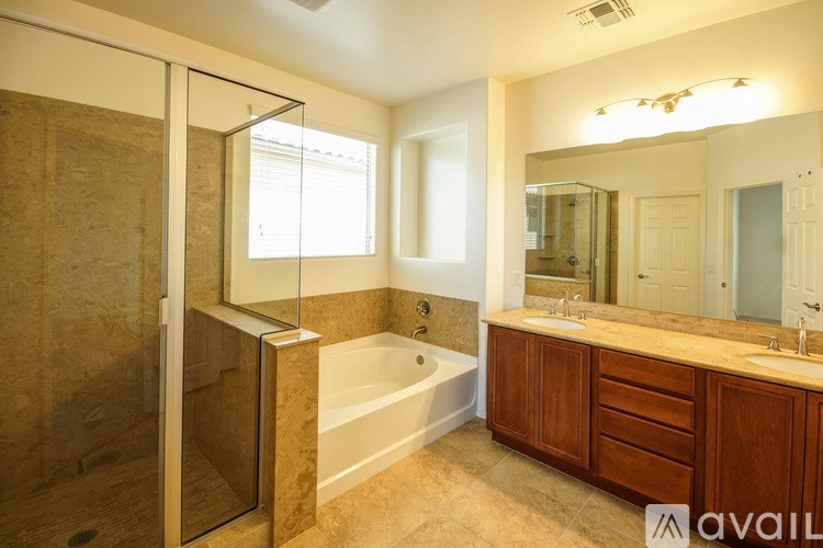 A bathroom with a tub, sink, and mirror.