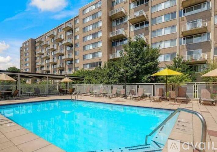 A large swimming pool in front of a residential building.