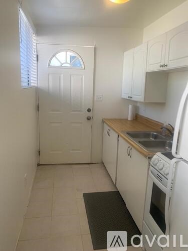 A kitchen with white cabinets and a white oven.