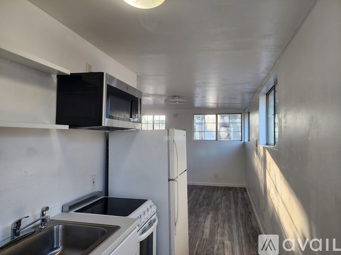 A kitchen with white cabinets and a wooden countertop.
