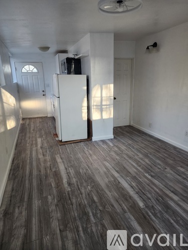 A white bathroom with a toilet and a shower.