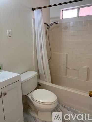 A white toilet and sink in a bathroom.