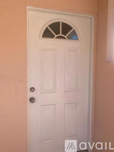 A white door with a glass window above the handle.