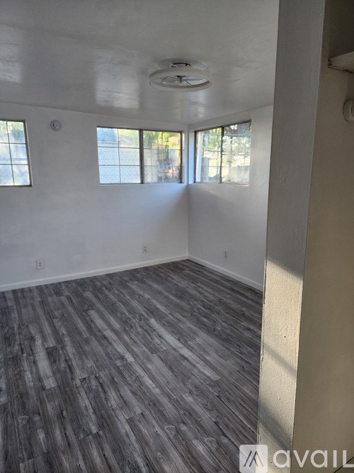 A room with a grey floor and a window.