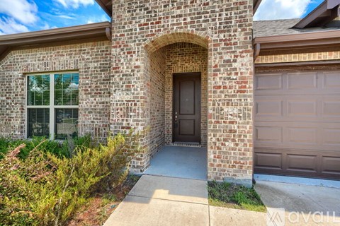 A house with a brown door and a window is for sale.