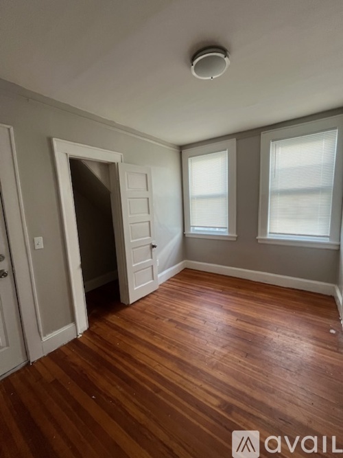 A room with wooden floors and a white door.