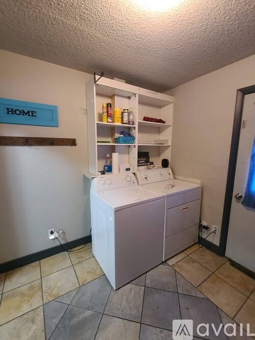 A bathroom with a white cabinet and a blue sign on the wall.