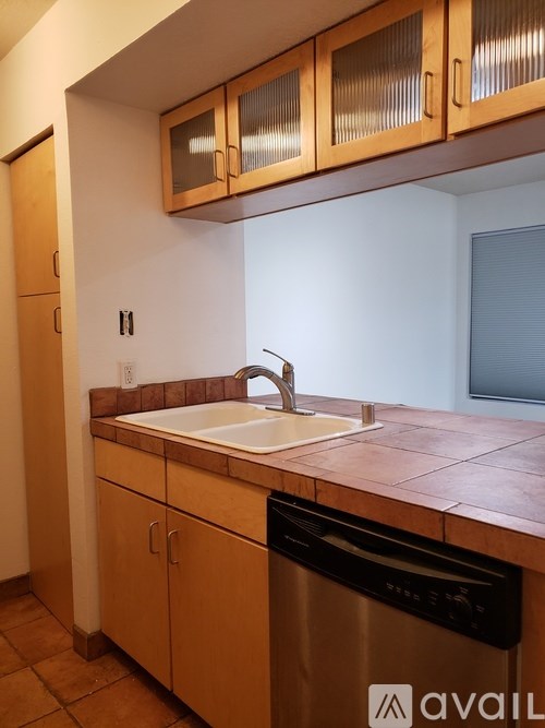 A kitchen with a sink and a dishwasher.