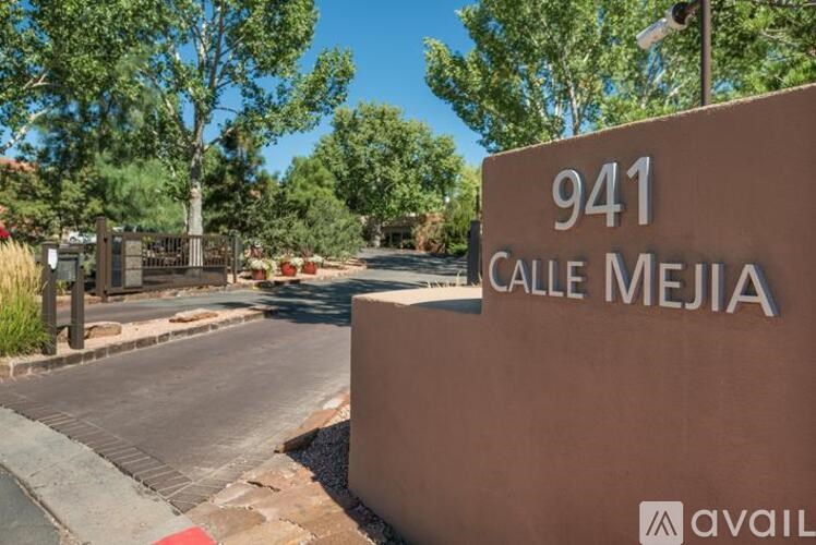 A sign that says 941 Calle Mejia in front of a street.