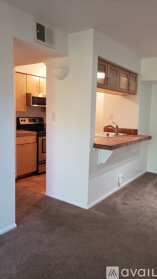A kitchen with a stove top oven and a microwave.