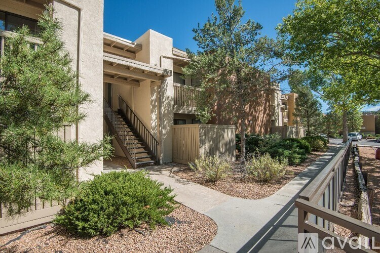 A sunny day at a residential area with apartment buildings and a clear blue sky.