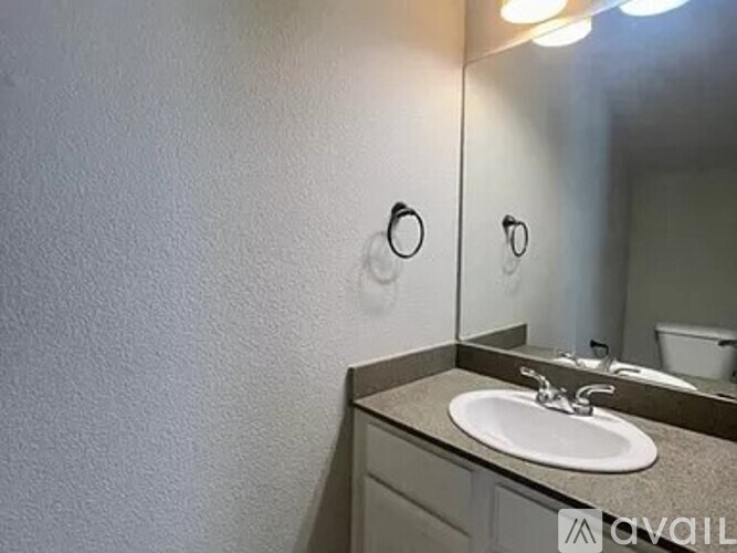 A bathroom with a sink and a mirror.