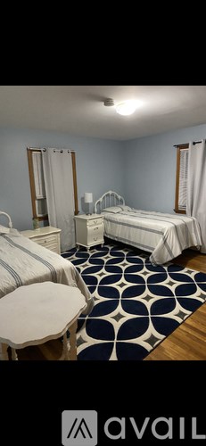 A bedroom with a bed, dresser, and mirror.