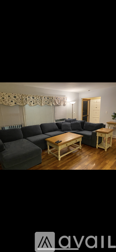 A living room with a grey sofa and wooden coffee table.