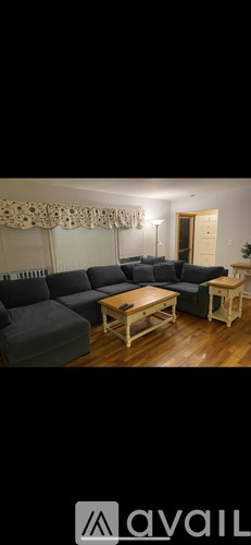 A living room with a grey sofa and wooden coffee table.