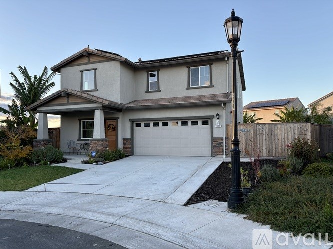 A house with a garage and a lamp post in front.