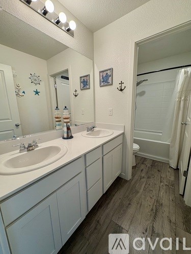 A bathroom with two sinks and a mirror.