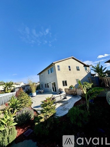 A house with a garden in front is for sale.