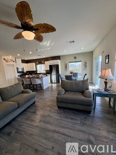 A living room with a fan and a couch.