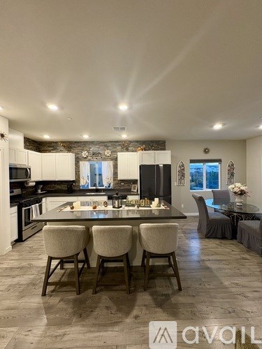 A modern kitchen with a dining table set for four.
