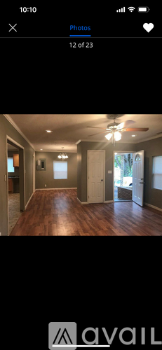 A room with wooden flooring and a ceiling fan.