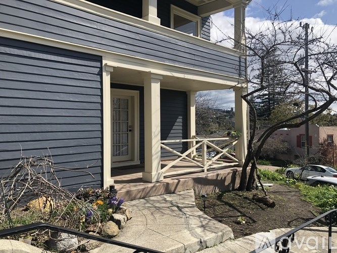 A blue house with a white door and a small porch.