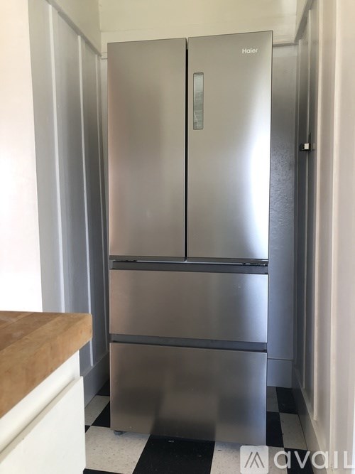 A stainless steel refrigerator in a kitchen.