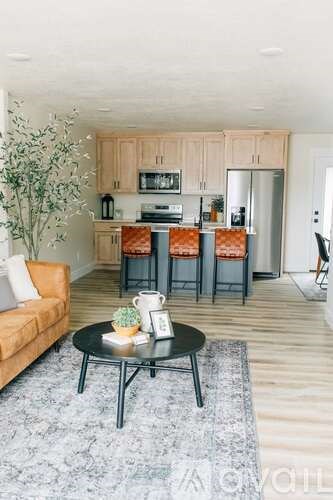A modern kitchen with a dining table and chairs.