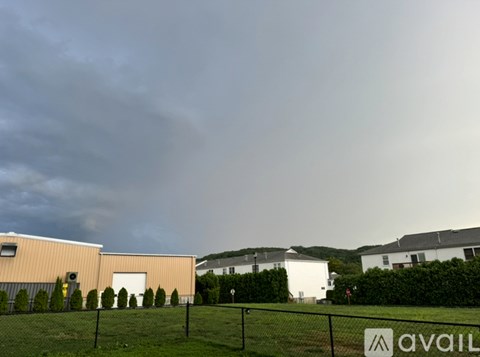 A sign that says "AVAIL" is in front of a building.