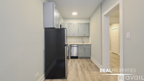 A kitchen with a stove top oven and a dishwasher.