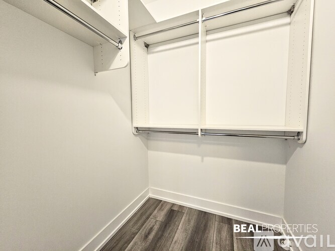 A white closet with a sliding door and a shelf above it.