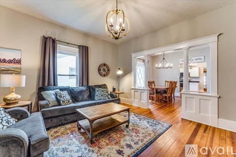 A living room with a grey couch and a wooden coffee table.