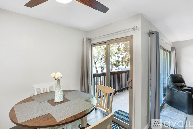 A dining room with a round table and chairs.