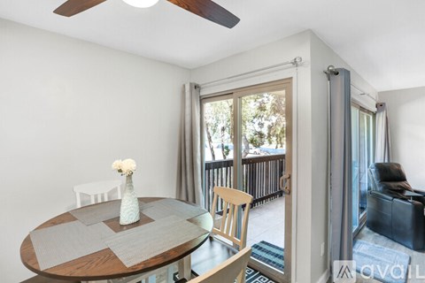 A dining room with a round table and chairs.