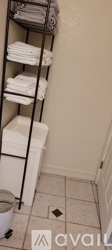 A bathroom with a towel rack and a toilet.