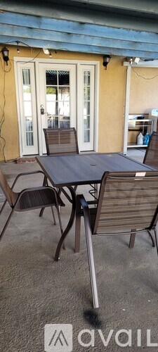 A patio with a table and chairs is shown.