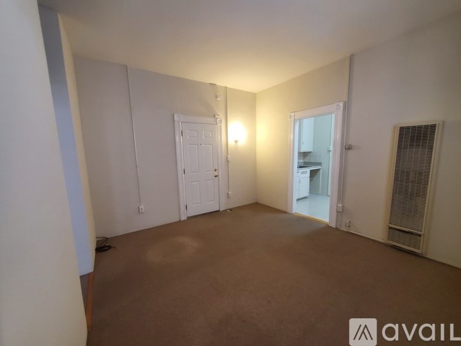 A room with white doors and a brown floor.