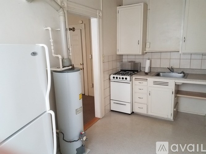 A kitchen with a white fridge, stove, and cabinets.