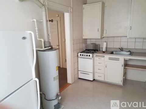A kitchen with a white fridge, stove, and cabinets.
