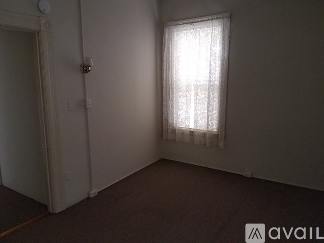 A room with a window and a door.