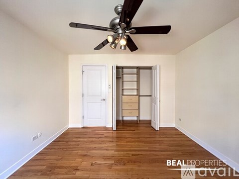 A room with a white door and a window in the background.