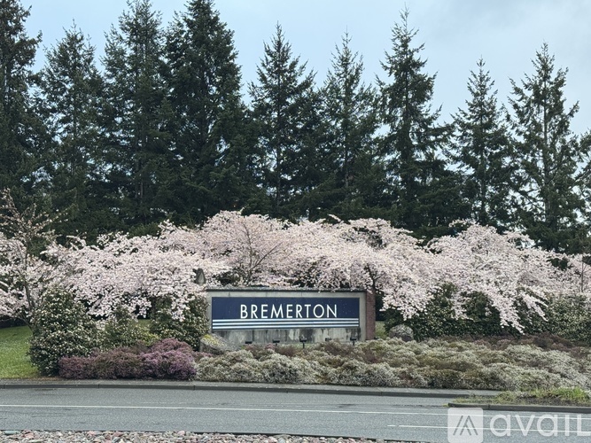 A sign that says Bremerton in front of some trees.