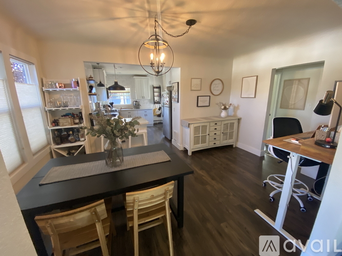 A dining room with a table set for four.