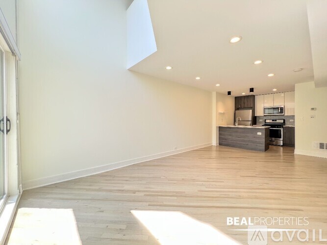 A white walk-in pantry with shelving and a wood floor.