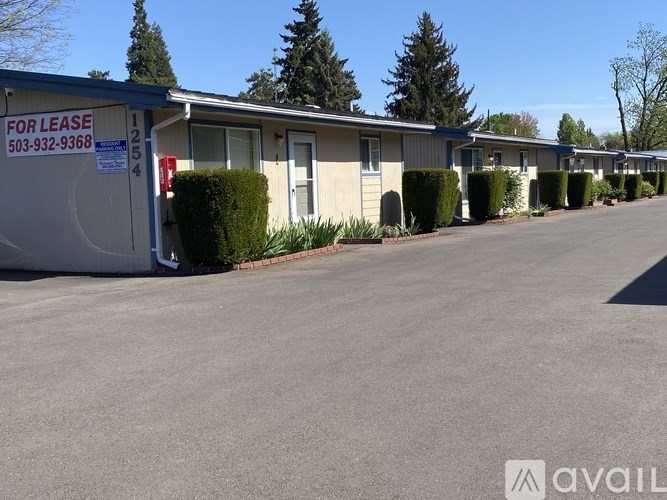 A row of houses with a FOR LEASE sign in front of them.