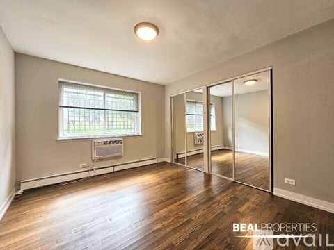 A spacious kitchen with dark wood cabinets and stainless steel appliances.
