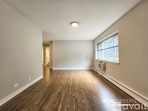 A white washing machine is in a small laundry room.