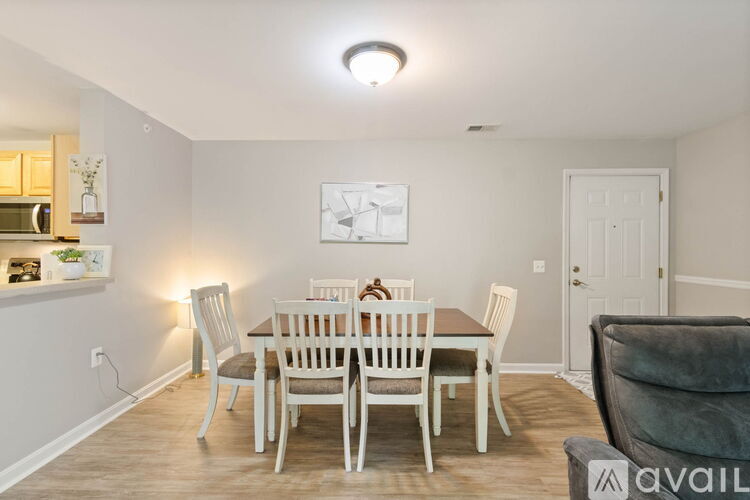 A dining room with a table set for six.