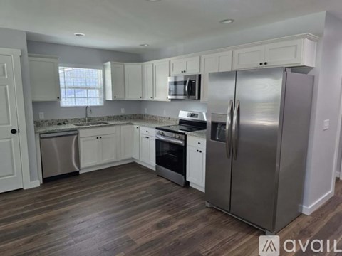 A kitchen with white cabinets and stainless steel appliances.